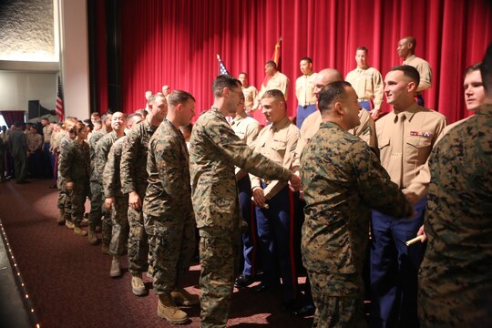 Corporals Course 2-16 graduates are congratulated by fellow Marines after their graduation ceremony aboard Marine Corps Air Station Miramar, California, Dec. 10. Corporals Course, a professional military education program hosted by 3rd Marine Aircraft Wing, is a re-introduction of the basic Marine Corps values to noncommissioned officers.(U.S. Marine Corps photo by Lance Cpl. Harley Robinson/Released)