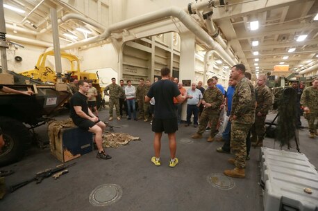 PACIFIC OCEAN (Dec. 8, 2015) U.S. Marines with the 15th Marine Expeditionary Unit’s Maritime Raid Force display the equipment they use on a day-to-day basis to family members in the well deck aboard the USS Anchorage (LPD 23). The 15th MEU is coming to the end of deployment and hosting a Tiger Cruise for family members to showcase life aboard the Anchorage. (U.S. Marine Corps photo by Sgt. Steve H. Lopez/Released)