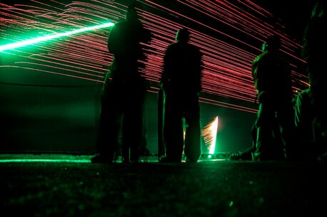 PACIFIC OCEAN (Dec. 9, 2015) - U.S. Marines with the 15th Marine Expeditionary Unit and Sailors with the Essex Amphibious Ready Group watch a 'fireworks' weapons display with the family members on the flight deck of amphibious assault ship USS Essex (LHD 2). The family members are on a Tiger Cruise from Hawaii back to California to experience the day-to-day life of their Marines and Sailors.  (U.S. Marine Corps photo by Sgt. Elize McKelvey/Released)