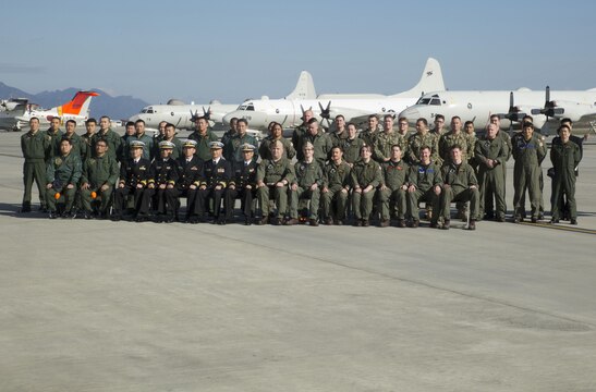 Members of the Japan Maritime Self-Defense Force Air Reconnaissance Squadron VQ-81 and Fleet Air Reconnaissance Squadron VQ-1 pose for a group picture at Marine Corps Air Station Iwakuni, Japan, Dec. 8, 2015. VQ-1 came to MCAS Iwakuni for an annual unit exchange between VQ-1 and VQ-81. The two units discussed their plans to increase their unit interoperability, strengthening the bond between the two units.
