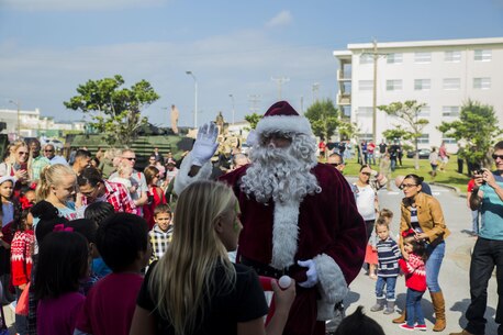 Santa Claus arrives for the event, Santa’s Little Helper, on Camp Hansen, Okinawa, Japan, Dec. 12, 2015. The event also had Santa fast rope out of a helicopter, fake snow, a bouncy castle, face painting and food served. The event was hosted by Combat Assault Battalion, 3rd Marine Division, III Marine Expeditionary Force and Marine Corps Community Services. (U.S. Marine Corps photo by Cpl. Tyler S. Giguere/Released)