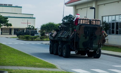 Santa Claus arrives in a Light Armored Vehicle for the event, Santa’s Little Helper, on Camp Hansen, Okinawa, Japan, Dec. 12, 2015. The event also had Santa fast rope out of a helicopter, fake snow, a bouncy castle, face painting and food served. The LAV is with Combat Assault Battalion, 3rd Marine Division, III Marine Expeditionary Force. (U.S. Marine Corps photo by Cpl. Tyler S. Giguere/Released)