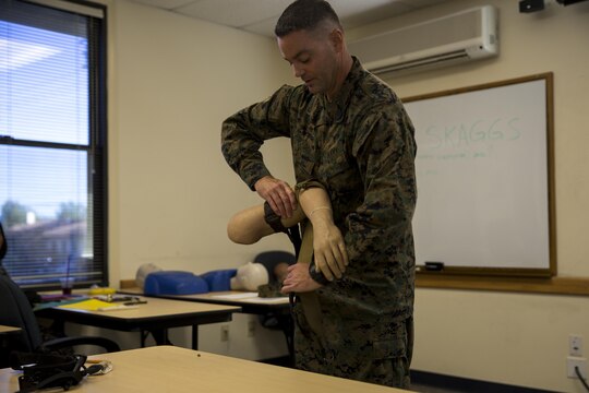 MARINE CORPS BASE CAMP PENDLETON, Calif. – Petty Officer 2nd Class Mark Skaggs, an aeromedical safety corpsman with Marine Aircraft Group 39 and Pensacola, Fla. native, demonstrates how to use a tourniquet during an Improvised Sudden Attack First Emergency Response (IMSAFER) course aboard Marine Corps Base Camp Pendleton, Calif., Dec. 14. The IMSAFER course covered life-saving techniques for use in potentially life-threatening scenarios.
