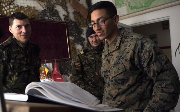 Lance Corporal Solis reads through letters to the Romanian Marines that previous units left after they worked with the Romanian Marines, Jan. 29. The Romanian Marines have worked with the Black Sea Rotational force for multiple years in several different operations and exercises. 