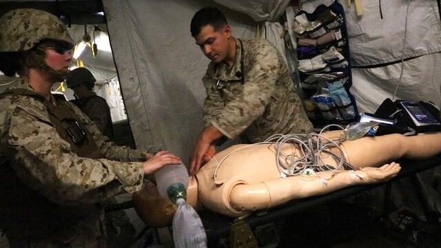 Sailors with Alpha Surgical Company, 1st Medical Battalion, 1st Marine Logistics Group, treat a simulated casualty during an en-route care exercise aboard Camp Pendleton, Calif., Jan. 28, 2015. During the four-day exercise, corpsmen trained to prepare a Special-Purpose Marine Air-Ground Task Force group that is going to forward deploy later this year. The more than 40 corpsmen set up a shock trauma platoon facility, or mobile emergency room, to treat simulated casualties. The casualties were stabilized in the STP and then flown out via aircraft. (U.S. Marine Corps photo by Sgt. Laura Gauna/Released)