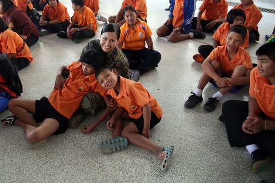 Lance Cpl. Sherry L. Eaton sits with children from Nakhon Ratchasima Panyonnookun School, February 12, during a community outreach event. The school provides education for 295 children with disabilities such as autism, Down syndrome, hearing loss, and attention deficit hyperactivity disorder. Marines with 1st Marine Aircraft Wing and members of the Royal Thai Air Force volunteered at the school during Exercise Cobra Gold 2015 to spend time in the community.  Eaton is an aviation technician with Marine All Weather Fighter Attack Squadron 533, attached to Marine Aircraft Group 12, 1st Marine Aircraft Wing, III Marine Expeditionary Force, under the Unit Deployment Program.  For more information on Exercise Cobra Gold, please visit the official Facebook page at http://www.facebook.com/ExerciseCobraGold.