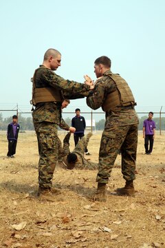 Students from Yothinnukun School watch a demonstration of Marine Corps Martial Arts at during Friendship Day held by Royal Thai Air Force Wing 1 and U.S. Marines at Royal Thai Air Force Base Korat during Exercise Cobra Gold 2015, Feb. 13. Students also observed demonstrations about Explosive Ordnance Disposal, Aircraft Rescue Firefighting, and Navy Corpsmen basic medical procedures. Cobra Gold 2015 is a Thailand /United States co-sponsored, multinational and joint theater security cooperation exercise, conducted annually in the Kingdom of Thailand, with 25 nations participating. This year there is an increased focus on Humanitarian Civic Action, community engagement, and medical activities to support the needs and humanitarian interests of civilian populations around the region. For more information on exercise Cobra Gold, please visit the official Facebook page at http://www.facebook.com/ExerciseCobraGold.