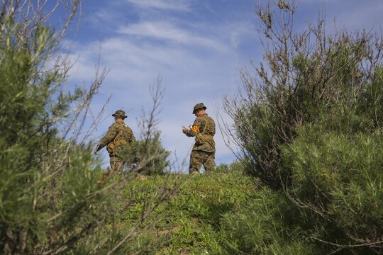 Recruits Jacob R. Kottman and Chainey L. Ellis, (right to left) Platoon 2105, Echo Company, 2nd Recruit Training Battalion, trek toward their mark during the Land Navigation Course at Edson Range, Marine Corps Base Camp Pendleton, Calif., Jan. 22.  Prior to starting the event, recruits received classes on land navigation techniques and how to properly use a map and compass while out in the field.
