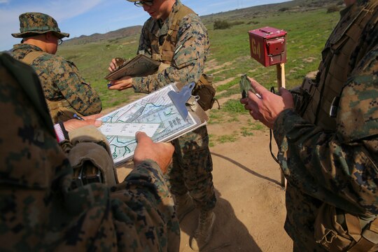 Recruits from Platoon 2105, (left to right) Echo Company, 2nd Recruit Training Battalion, determine the direction to their next mark during the Land Navigation Course at Edson Range, Marine Corps Base Camp Pendleton, Calif., Jan. 22.  In a modern day of electronics and global position satellite systems, some may argue the relevance of teaching these techniques to recruits.  Out in the field environments, though, these systems have the tendency to fail, causing one to resort to the basic skills taught here.