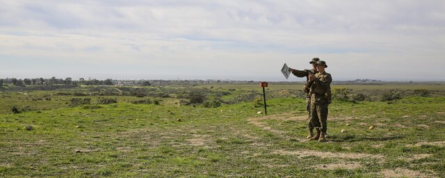 Recruits Jacob R. Kottman and Chainey L. Ellis, (left to right) Platoon 2105, Echo Company, 2nd Recruit Training Battalion, determine the direction to their next mark during the Land Navigation Course at Edson Range, Marine Corps Base Camp Pendleton, Calif., Jan. 22.  Going through the course with minimal, or at times no supervision, recruits had a chance to get a sense of the critical factor of learning and properly executing the techniques they were taught.