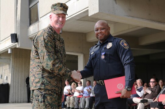 Brig. Gen. Edward D. Banta presents Officer Charles E. Horton with a Meritorious Civilian Service award during an awards ceremony, Jan. 22. Horton saved the life of a newborn infant Aug. 20 by assisting in the birth of the infant and then performing CPR on the infant until it took its first breath. Brig. Gen. Banta is the Commanding General of Marine Corps Installations West/Marine Corps Base.
(Photo by Lance Cpl. Asia J. Sorenson/Released)
