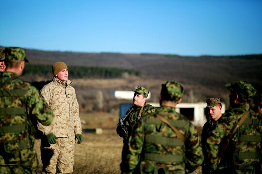 Cpl. Jordan Holly offers a period of instruction to Serbian soldiers in a military operations on urbanized terrain scenario. Serbians conducted MOUT training with Marines at Novo Selo training area in Bulgaria, Jan. 17, 2015, as part of Exercise Platinum Lion.