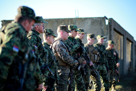 A group of Serbian soldiers listen to a critique of their performance at the conclusion of a scenario in military operations on urbanized terrain. Serbians conducted MOUT training with Marines at Novo Selo training area in Bulgaria, Jan. 17, 2015, as part of Exercise Platinum Lion.
