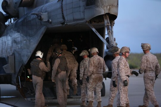 A CH-53E Super Stallion with Marine Heavy Helicopter Squadron (HMH) 466 lands to receive Marines with Golf Company, Battalion Landing Team 2nd Battalion, 1st Marine Regiment at Marine Corps Base Camp Pendleton, California, July 2. The helicopter’s air crew and infantry Marines conducted night fast-rope training, a useful skill for both units. (U.S. Marine Corps photo by Sgt. Lillian Stephens/Released)