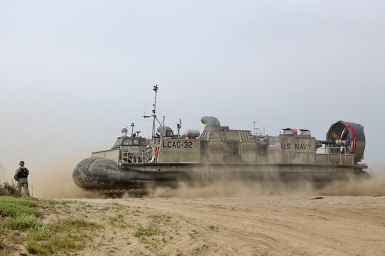 U.S. Navy Landing Craft Air Cushioned (LCAC) vehicle from Assault Craft Unit 5 lands on Red Beach as part of a loading exercise along side Combat Logistics Battalion 11, Headquarters Regiment, 1st Marine Logistics Group aboard Camp Pendleton, Calif., June 23, 2015. This loading exercise reinforces the Marine Corps role as an amphibious force in readiness by maintaining capabilities through realistic training. (U.S. Marine Corps photo by Lance Cpl. Lauren Falk/Released)
