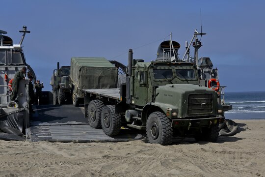 A Landing Craft Air Cushioned vehicle from Assault Craft Unit 5 unloads a Medium Tactical Vehicle Replacement onto Red Beach as part of a loading exercise along side Combat Logistics Battalion 11, Headquarters Regiment, 1st Marine Logistics Group, aboard Camp Pendleton, Calif., June 23, 2015. This loading exercise reinforces the Marine Corps' role as an amphibious force in readiness by maintaining capabilities through realistic training.(U.S. Marine Corps photo by Lance Cpl. Lauren Falk/Released)
