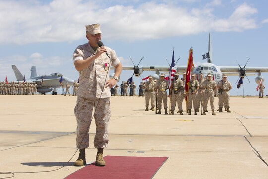 Col. Rick Uribe, former commanding officer of Marine Aircraft Group (MAG) 11, addresses Marines, Sailors, family members and friends during his change of command ceremony aboard Marine Corps Air Station Miramar, California, July 10. Uribe was awarded the Legion of Merit during the ceremony and will continue his career at Headquarters Marine Corps, Washington, D.C. (U.S. Marine Corps photo by Sgt. Lillian Stephens)