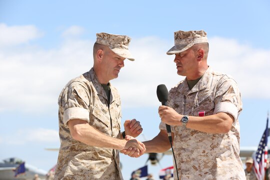 Col. William Swan, commanding officer of Marine Aircraft Group (MAG) 11, shakes hands with Col. Rick Uribe, former commanding officer of MAG-11, during his change of command ceremony aboard Marine Corps Air Station Miramar, California, July 10. Swan succeeded Col. Rick Uribe as the new commanding officer for MAG-11. (U.S. Marine Corps photo by Sgt. Lillian Stephens)