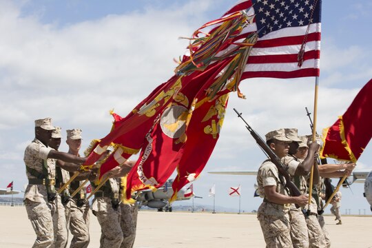 A color guard presents arms during a change of command ceremony for Marine Aircraft Group (MAG) 11 aboard Marine Corps Air Station Miramar, California, July 10. Col. William Swan, commanding officer of MAG-11,  succeeded Col. Rick Uribe, former commanding officer of MAG-11. (U.S. Marine Corps photo by Sgt. Lillian Stephens)