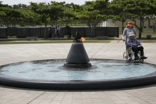 Two women walk past the Eternal Flame June 27 at Peace Memorial Park, Itoman City, Japan. United Service Organizations, Okinawa treated its volunteers to a tour of the park as it commemorated 70 years of peace between the U.S. and Japan. (U.S. Marine Corps Photo by Lance Cpl. Jessica Collins/Released)