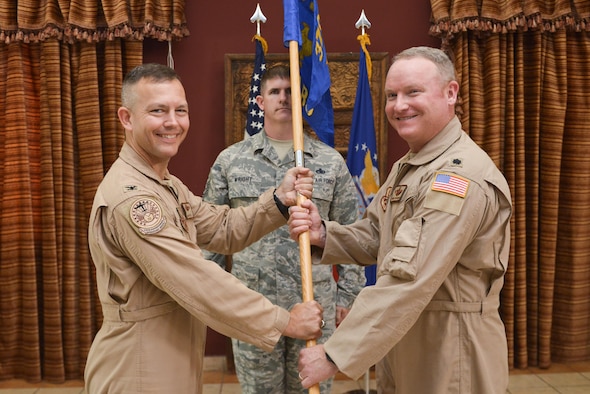 Col. James Dittus, 379th Expeditionary Operations Group commander passes the guideon to Lt. Col Ronald Schochenmaier, 22d Expeditionary Air Refueling Squadron commander, during the assumption of command ceremony for the 22d EARS July 24th 2015 at Al Udeid Air Base, Qatar. The 22d was first formed in 1939 primarily as a bomb squadron for World War II. In 2002 it was inactivated as the 22d Air Refueling Squadron and is now re-designated as the 22d EARS supporting operations from Al Udeid Air Base. (U.S. Air Force photo/Staff Sgt. Alexandre Montes)
