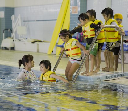 Students from Kawashimo Yochien in Iwakuni City, celebrate their last day at the IronWorks pool aboard Marine Corps Air Station Iwakuni, Japan, July 21, 2015. Coming to the station pool is an honor unique to the senior kindergarten class and is a 30-year tradition.