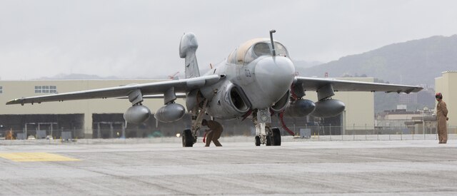 A Marine Tactical Electronic Warfare Squadron 2 (VMAQ 2) EA-6B, stops for a brake check before pulling into the hot refueling pits for the first time aboard Marine Corps Air Station Iwakuni, Japan, July 22, 2015. Prowlers have a wingspan of 53 feet, but the hot pits only accommodate for a wingspan of 50 feet. U.S. Naval Air System Command approved a waiver making it possible for the Prowlers to use the hot pits after deeming the pits safe with enough clearance to host a Prowler. 