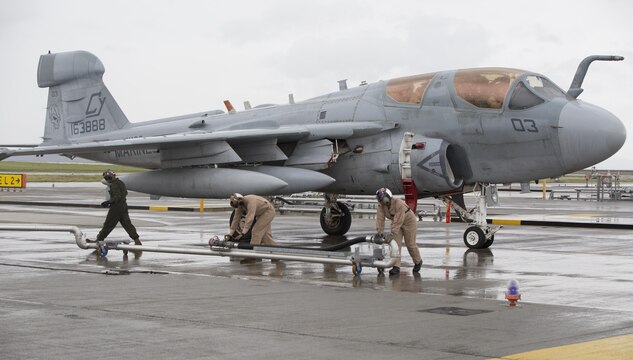 Marines with Station Fuels Division refuel a Marine Tactical Electronic Warfare Squadron 2 (VMAQ-2) EA-6B Prowler aboard Marine Corps Air Station Iwakuni, Japan, July 22, 2015. The efficiency of using the hot pits to refuel enables the Prowler to accomplish its mission which is to suppress enemy air defense in support of strike aircraft and ground troops.