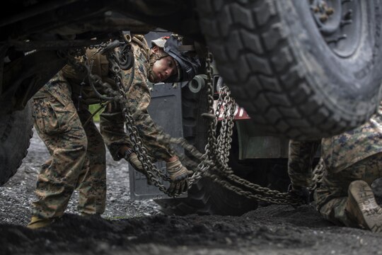 Cpl. Gerardo Becerra, a motor transport operator with Combat Logistics Company 36, attaches an abandoned vehicle to an AMK-36 wrecker during Exercise Dragon Fire 2015 at Combined Arms Training Center Camp Fuji, Japan, July 24. Convoy and recovery operations are one of the many activities Marines and Sailors practiced during the exercise. CLC-36 conducts this exercise annually to refresh the minds of the service members of all the tactical skill sets that leaned about in boot camp and Marine combat training. This training environment simulated a combat zone in order to further develop the service members’ combat mindset to prepare them for the mental and physical stress of a combat zone.