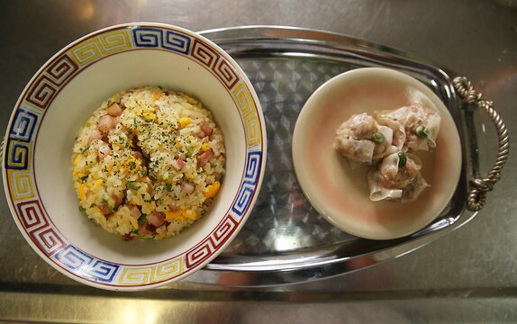Marine Corps Air Station Iwakuni residents plate their finished Shumai and traditional fried rice during a Japanese cooking class at Fukushi Kaikan in Iwakuni, Japan, July 24, 2015. Shumai is traditionally served in small steamer baskets or on small plates and is one of three Oriental dishes prepared during the class. The station’s cultural adaptation program coordinates the class three times a year, and it is one of many ways to indulge in local cuisine.