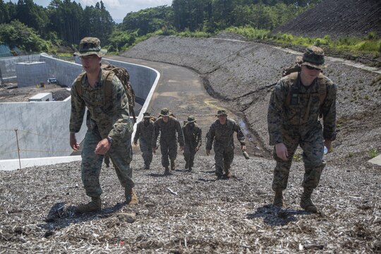 Marines with Combat Logistics Company 36 navigate through training grounds during Exercise Dragon Fire 2015 at Combined Arms Training Center Camp Fuji, Japan, July 27. Using only a map, protractor and compass, service members navigated in an unfamiliar, highly vegetated terrain with limited time to complete their mission. Exercise Dragon Fire is conducted annually allowing service members to strengthen their combat readiness, a vital asset to the Marine Corps’ mission.