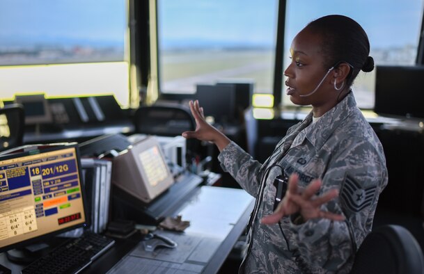 Tech. Sgt. Charmaine Johnson, 374th Operations Support Squadron tower watch supervisor, monitors the two staff sergeants working in the control tower at Yokota Air Base, Japan, May 8, 2015. Johnson’s role is to ensure that all rules and regulations are followed during tower procedures. (U.S. Air Force photo by Senior Airman Michael Washburn/Released)