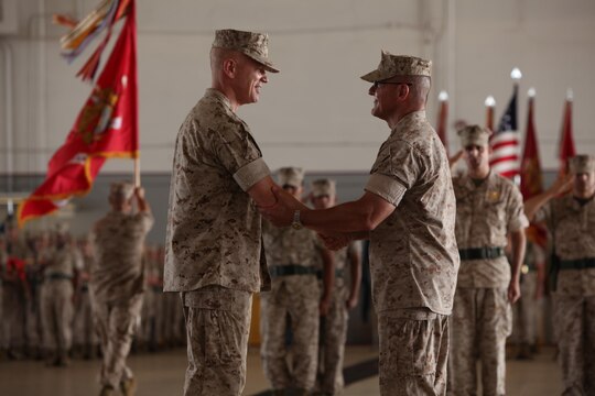 Brig. Gen. Paul J. Rock Jr., left, shakes hands with Maj. Gen. Robert F. Hedelund during a change of command ceremony at Marine Corps Air Station Cherry Point, N.C., June 18, 2015. Hedelund relinquished his post as 2nd Marine Aircraft Wing commanding general to Rock during the ceremony.