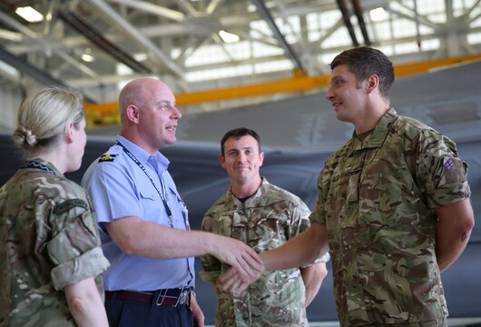 Air Commodore Harvey Smyth, left, shakes hands with Squadron Leader Hugh Nichols during a tour of Marine Fighter Attack Training Squadron 501, June 16. There are currently 14 U.K. pilots and maintainers with VMFAT-501 aboard Marine Corps Air Station Beaufort. Smyth is the lightning force commander, responsible for the F-35 program in the Royal Air Force. Nichols is the UK senior national representative for United Kingdom Royal Air Force pilots assigned to VMFAT-501, Marine Aircraft Group 31.