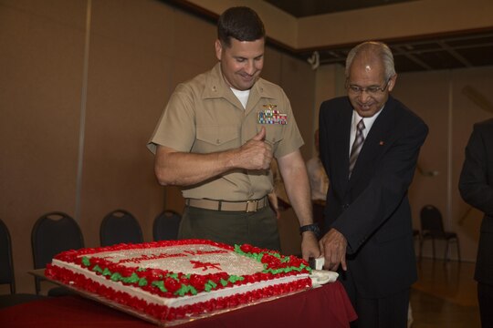 Col. Robert V. Boucher, left, commanding officer of MCAS Iwakuni, and Hiroshi Fujisawa, right, a tractor-trailer driver with Logistics, cut the cake at the retirement ceremony inside Club Iwakuni aboard Marine Corps Air Station Iwakuni, Japan, June 25, 2014. This ceremony is held annually to honor all of the Japanese contractors retiring within the year and to show the station’s appreciation for their faithful service.