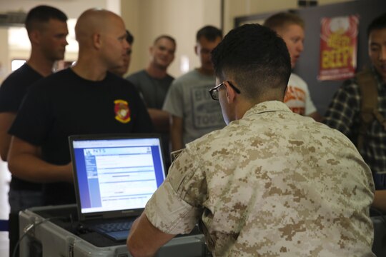Sergeant Patrick Harger, a platoon sergeant assigned to Special-Purpose Marine Air-Ground Task Force Crisis Response-Africa, processes Marines acting as role players through a non-combatant evacuation operation tracking system during a simulated evacuation  aboard Naval Air Station Sigonella, Italy, May 27, 2015. Harger was one of more than 10 Marines assisting in processing about 15 role players through an improvised evacuation control center, which helped improve the Marines’ evacuation control center skills. (U.S. Marine Corps photo by Cpl. Lucas Hopkins/Released)