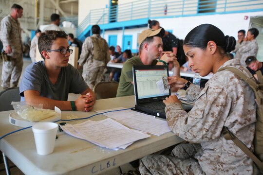 Marines with Combat Logistics Battalion 6, process American citizens at the evacuation command center during a simulated embassy evacuation aboard Naval Air Station Oceana, Va. The ECC is part of a week-long Special Purpose Marine Air Ground Task Force - Crisis Response- Africa certification exercise, the final step in the pre-deployment training. (U.S. Marine Corps photo by Staff Sgt. Vitaliy Rusavskiy/ Released)