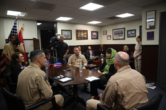 Captain Niloofar Rahmani, the first female fixed-wing pilot in the Afghan Air Force, speaks with Maj. Gen. Michael Rocco, 3rd Marine Aircraft Wing commanding general, and Col. John Farnam, commanding officer of Marine Corps Air Station Miramar, Calif. aboard the air station, March 9. Rahmani received the 2015 International Women of Courage award by the Department of state for her courage in advocating women’s rights despite personal risk.