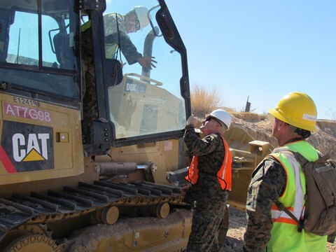 Major Gen. Vincent Coglianese, left, 1st Marine Logistics Group Commanding General, talks with a combat engineer Marine with 7th Engineer Support Battalion, 1st MLG, during a visit to El Centro, California, Feb. 26, 2015.  Marines arrived during January, providing engineering support to construct an all-weather road in El Centro, California, along the United States-Mexico border to increase U.S. border patrol mobility and support the interdiction of transnational threats. (U.S. Marine Corps photo by 1st Lt. Thomas Gray/ Released)