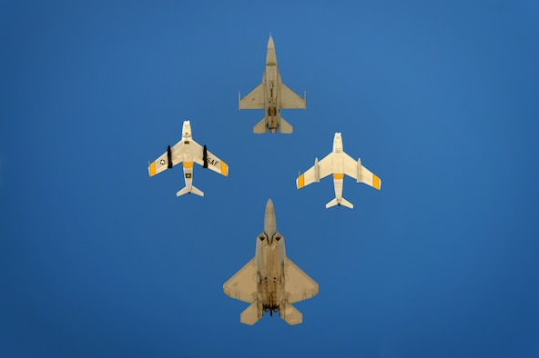 U.S. Air Force Capt. Craig Baker, F-16 Viper Demo Team pilot, leads the formation of an F-22 Raptor and the F-86 Sabre during the Heritage Flight Certification and Training Course at Davis-Monthan Air Force Base, Ariz., Feb. 27, 2015. During the four day course, Baker learned to fly Heritage Flights with several HF aircraft. (U.S. Air Force photo by Senior Airman Jensen Stidham/Released) 