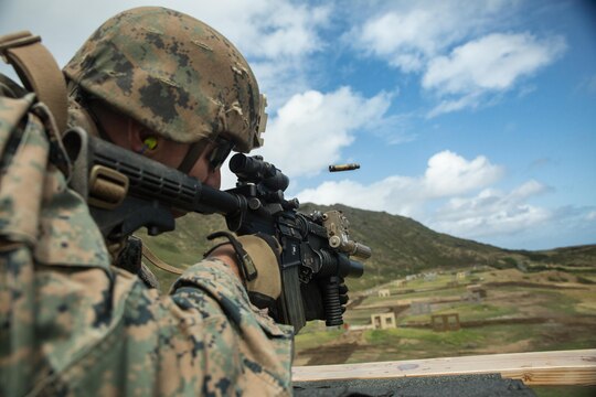 Cpl. Clayton Abbott, a Marine with Scout Sniper Platoon, Weapons Company, 2nd Battalion, 3rd Marine Regiment fires his M4 service rifle down range at Bluff Battery aboard Marine Corps Base Hawaii, March 5, 2015. Abbott was one of the first service members to test out the new urban terrain, unknown-distance range equipped with 20 static and 13 moving targets. The new range is comprised of three wooden structures that are three stories tall. The range creates a realistic urban terrain-training environment. (U.S. Marine Corps photo by Lance Cpl. Brittney Vella/Released)