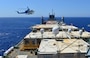 A helicopter approaches the U.S. ship MV Cape Ray to drop off cargo in the Mediterranean Sea, Aug. 4, 2014. U.S. Navy photo by Seaman Desmond Parks