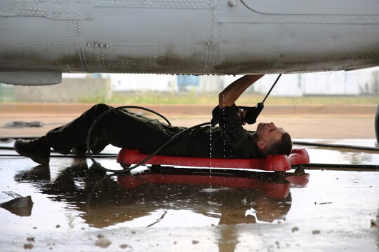 Lance Cpl. Isaac Powell, a CH-53E Super Stallion helicopter mechanic with Marine Heavy Helicopter Squadron 463, power washes the underbelly of a helicopter, March 17, 2015, in preparation for an inspection aboard Marine Corps Base Hawaii. The unit prepared five CH-53Es to send to Marine Rotational Force-Darwin, Australia later this year. It takes 1,500 man-hours per aircraft to make the aircraft inspection-ready for the deployment to Australia.