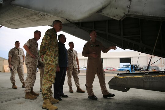 Royal Australian Air Force Wing Group Commander Rohan Gaskill, looks inside a CH-53E Super Stallion helicopter during a tour with Marines attached to Marine Heavy Helicopter Squadron 463 March 17, 2015 aboard Marine Corps Base Hawaii. The tour came a week before the unit's official inspection of five CH-53E Super Stallions slated to be sent to Marine Rotational Force-Darwin, Australia later this year. It takes 1,500 man-hours per aircraft to make the helicopters inspection-ready for the deployment.