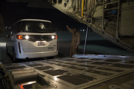Cpl. Casey Pryor, a crew master with Marine Aerial Refueler Support Squadron 152, guides the van into a Lockheed KC-130J Hercules aircraft in Kadena Air Base, Japan, March 20, 2015. Within the Marine Corps, the C-130 is the only aerial refueling platform and it’s the only aircraft capable of completing large scale transport and aerial delivery missions.