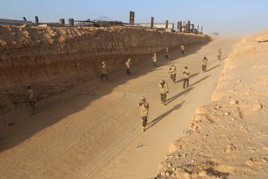 Mauritanian Fusilier Marins conduct a patrol during training near Nouadhibou, Mauritania, Feb. 18, 2015. Approximately 20 U.S. Marines, Sailors and Coastguardsmen with Special-Purpose Marine Air-Ground Task Force Crisis Response-Africa trained with the Mauritanians, practicing infantry skills, small boat operations, combat marksmanship and tactical combat casualty care. (Courtesy photo)