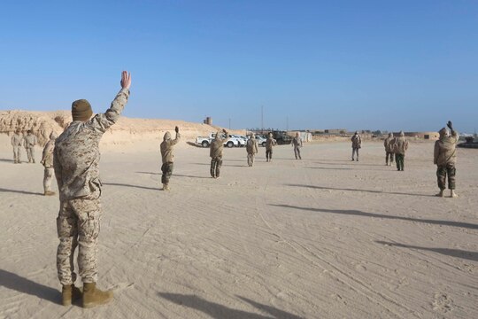 U.S. Marines with Special-Purpose Marine Air-Ground Task Force Crisis Response-Africa practice patrol formations and hand-and-arm signals with Mauritanian Fusilier Marins in Nouadhibou, Mauritania, Feb. 18, 2015. Approximately 20 U.S. Marines, Sailors and Coastguardsmen with SPMAGTF-CR-AF conducted infantry training and small boat operations with the Mauritanians to increase their capabilities and regional stability. (Courtesy Photo)