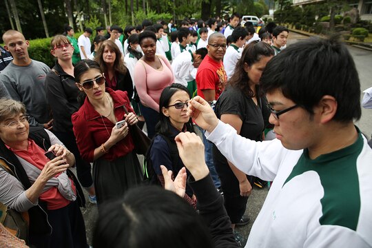 A Hirose-Iwakuni High School student presents a green tea leaf to Marine Corps Air Station Iwakuni, Japan, residents during a Cultural Adaption Program tea harvesting event in Iwakuni City, May 7, 2015. The students, guests and even elders from a local nursing home spent the afternoon selectively picking the green tea leaves that would later be fanned, steamed cooled, pressed, rolled and dried for everyone’s enjoyment. Through cultural exchanges like the Tea Harvesting event, station residents can broaden their knowledge about Japan while better solidifying a growing U.S.-Japanese relationship.
