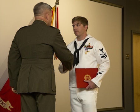 Major Gen. Joseph L. Osterman, commander, U.S. Marine Corps Forces Special Operations Command, awards Petty Officer 1st Class Kevin D. Baskin, special amphibious reconnaissance corpsman, 3d Marine Special Operations Battalion, the Silver Star Medal during a ceremony at Stone Bay aboard Camp Lejeune, N.C., March 20, 2015. Baskin was awarded for his actions in Afghanistan April 25, 2013. (U.S. Marine Corps Photo by Sgt. Scott A. Achtemeier / Released)