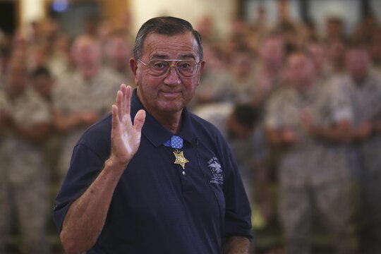 Col. Jay R. Vargas, a Congressional Medal of Honor recipient, waves at the camera after speaking to service members about the importance of finding help for those suffering from post-traumatic stress disorder May 12, 2015, at the Chaplain Joseph W. Estabrook Chapel aboard Marine Corps Base Hawaii. (U.S. Marine Corps photo by Lance Cpl. Harley Thomas/Released)